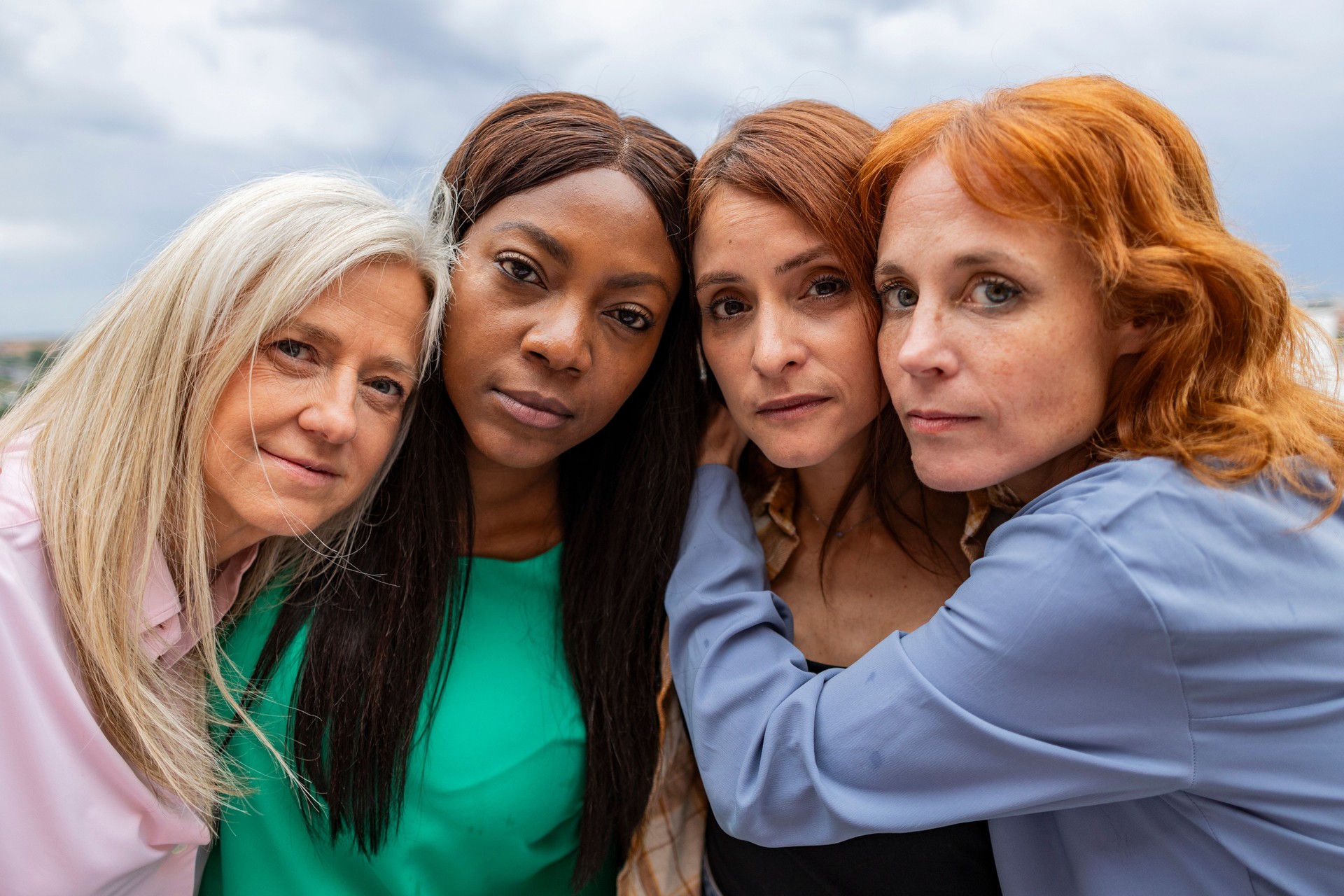 Four women embracing showing concept of female friendship